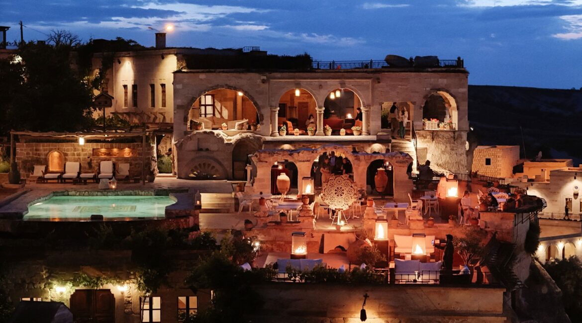 Museum Hotel Cappadocia illuminated at night with heated pool and valley views