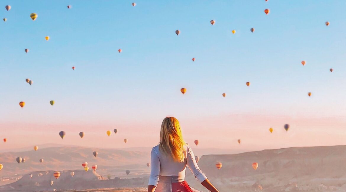 Guest enjoying sunrise hot-air balloon views at Museum Hotel Cappadocia