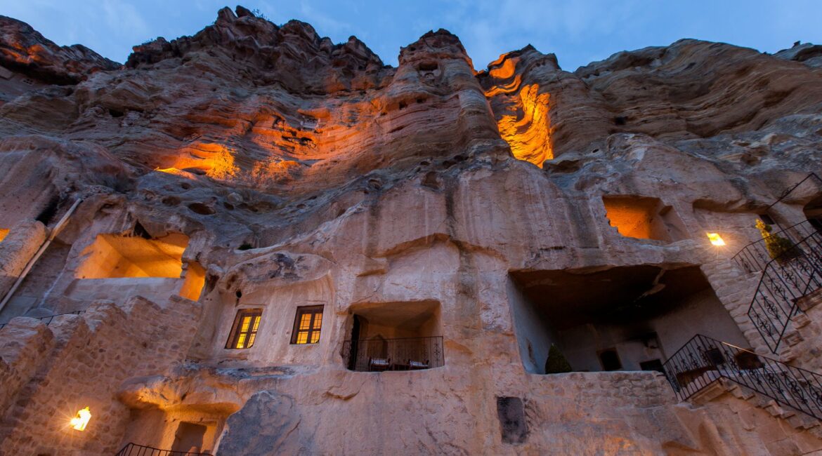 Illuminated cave houses at dusk in Cappadocia