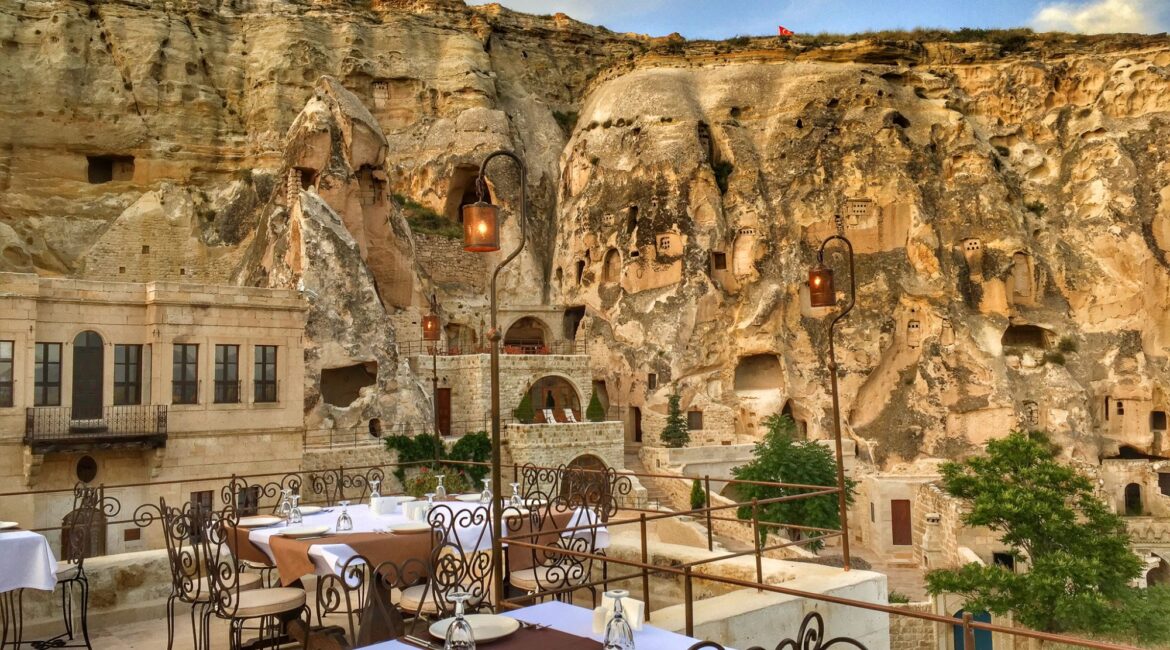 Terrace dining beneath Cappadocia's cave cliffs at Yunak Evleri