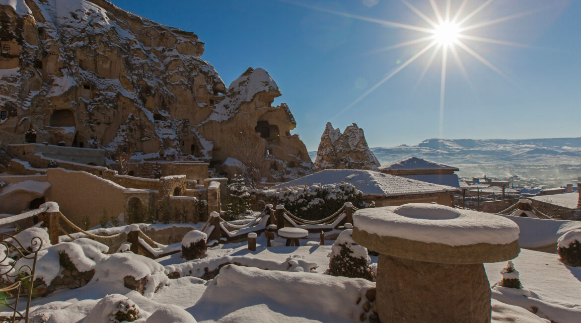 Snow-covered terrace and fairy chimneys at Yunak Evleri in winter, Cappadocia