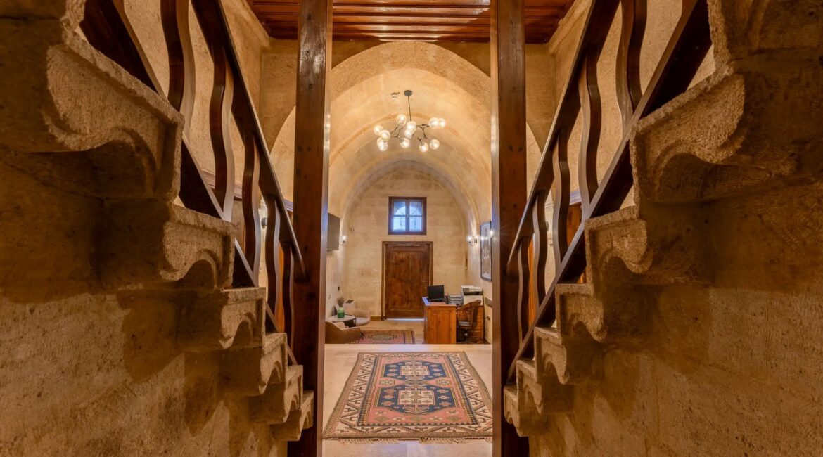 Grand stone staircase within the historic mansion at Asmali Konak Cave Suites, Urgup, Cappadocia