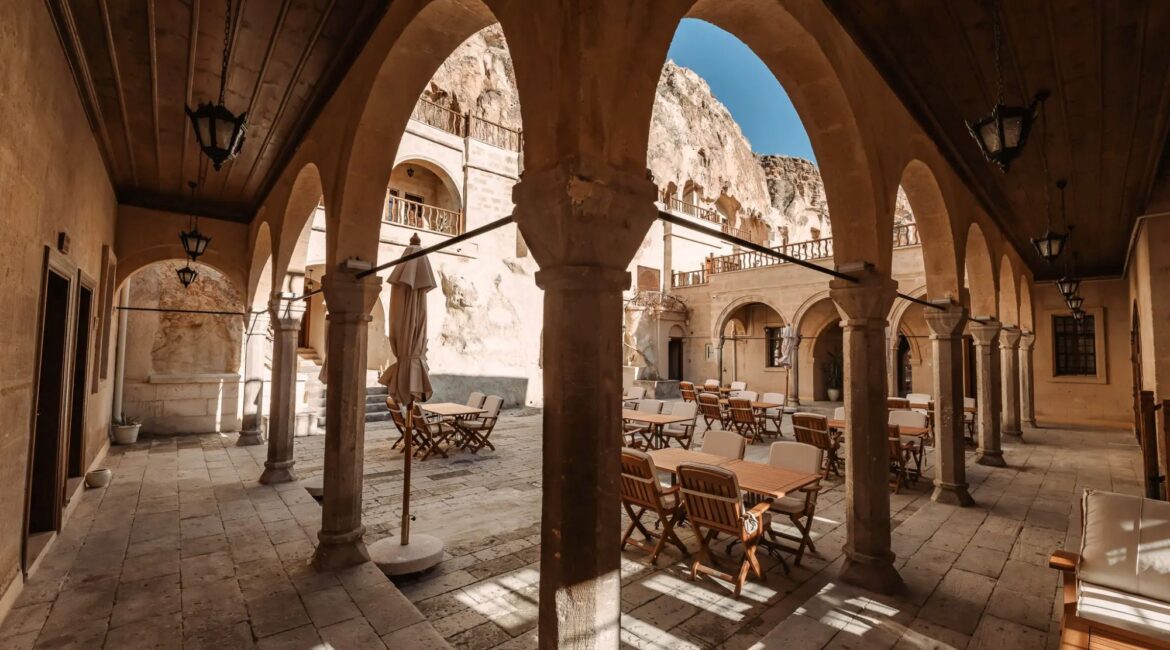 Traditional stone porticoes overlooking the historic courtyard at Asmali Konak Cave Suites, Urgup, Cappadocia