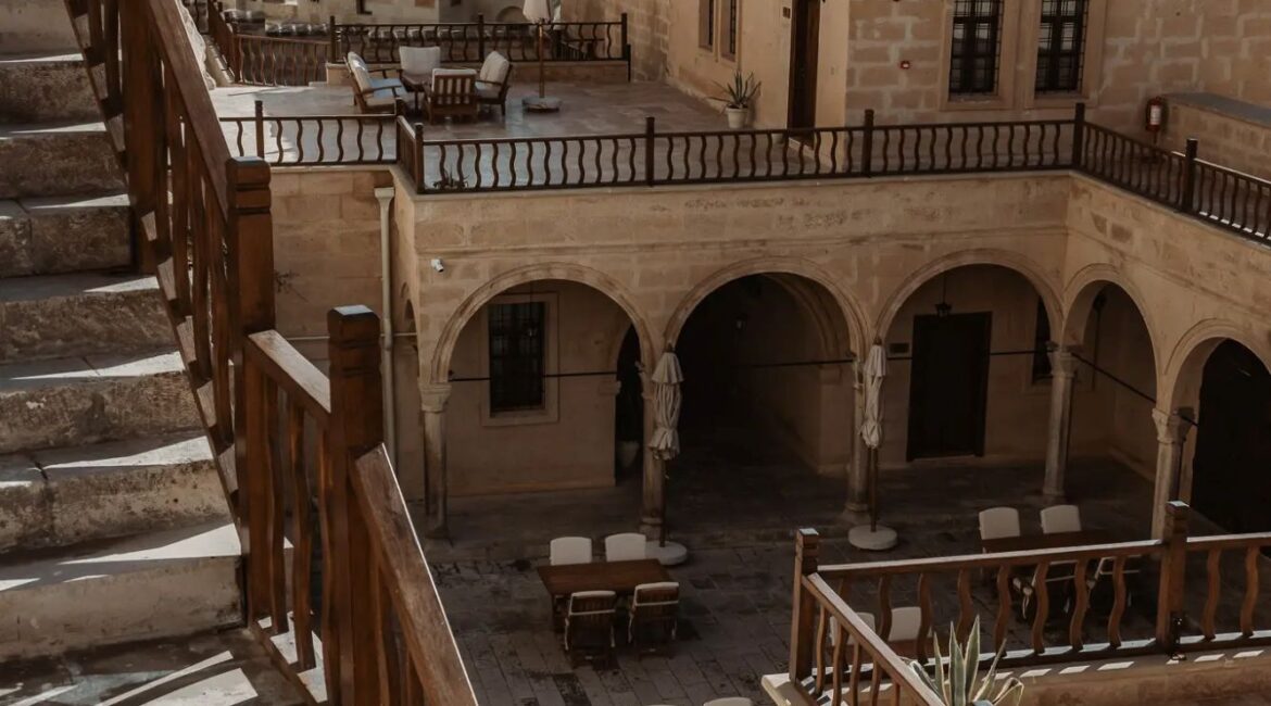 Historic portico courtyard and outdoor seating area at Asmali Konak Cave Suites, Urgup