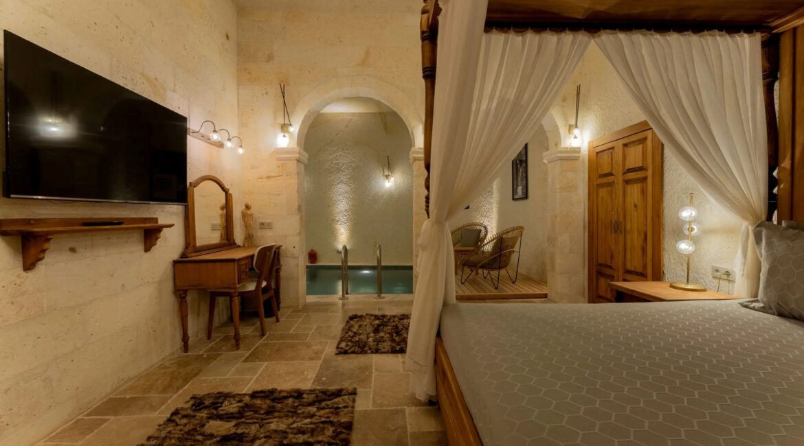 Romance Suite featuring a four-poster bed and private indoor pool at Asmali Konak Cave Suites