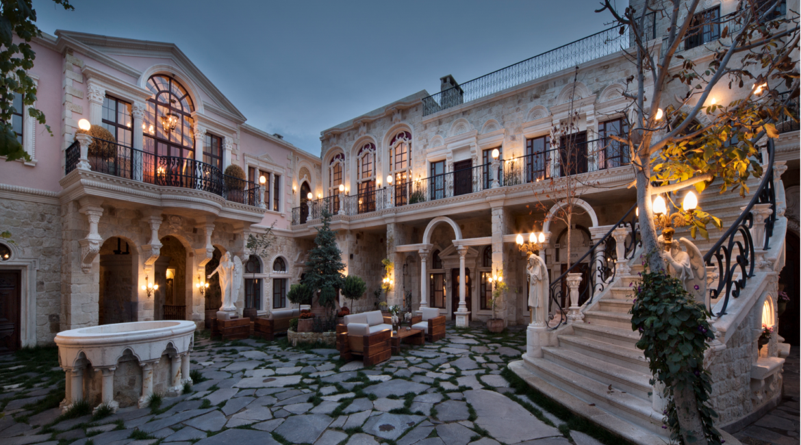 Historic courtyard at Sacred House Cappadocia illuminated at dusk