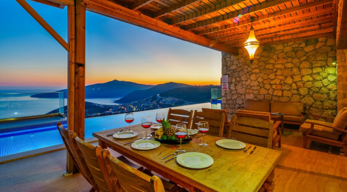 Covered outdoor dining terrace at Villa Sedir Ev in the evening