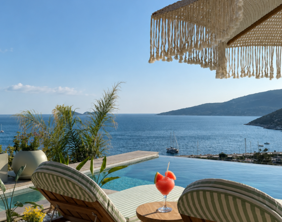 Outdoor seating terrace at Casa Pery Kalkan with panoramic views across Kalkan Bay.