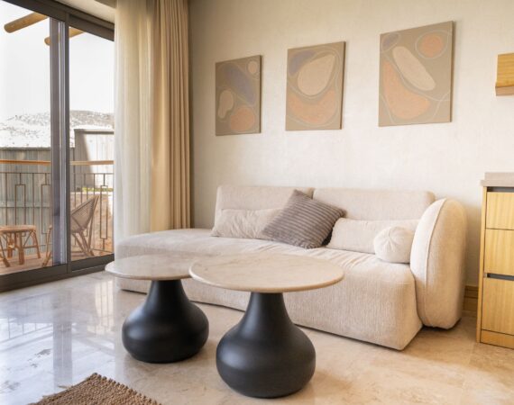 Lounge area in Suite Livia (Room 4) at Casa Pery with seating area, hanging chair and balcony overlooking Kalkan.