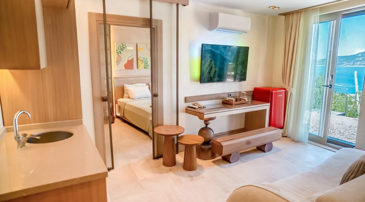 Junior Suite Harmonia (Room 1) at Casa Pery in Kalkan featuring a spacious sitting area, bedroom and contemporary Mediterranean interiors.