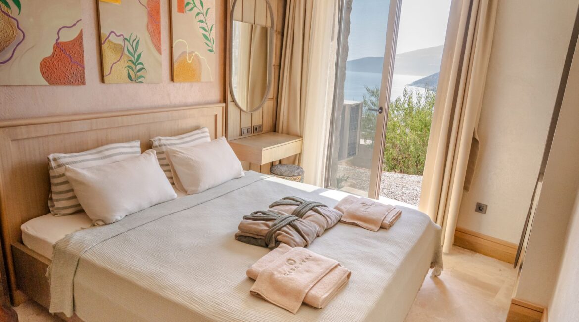 Bedroom in Junior Suite Harmonia (Room 1) at Casa Pery, Kalkan with handcrafted furnishings, natural textures and balcony views.