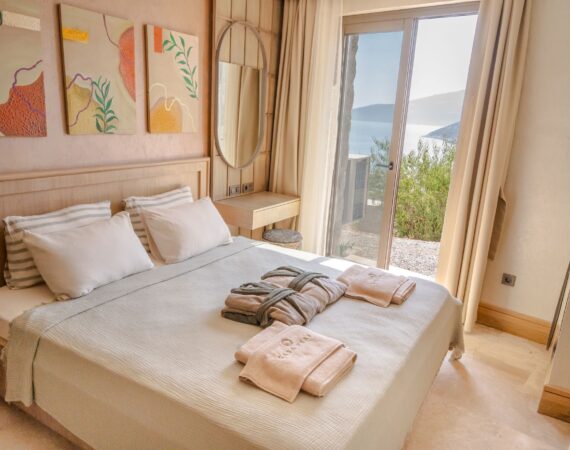 Bedroom in Junior Suite Harmonia (Room 1) at Casa Pery, Kalkan with handcrafted furnishings, natural textures and balcony views.