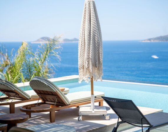 Infinity pool at Casa Pery in Kalkan with luxury sunbeds overlooking the Mediterranean Sea.