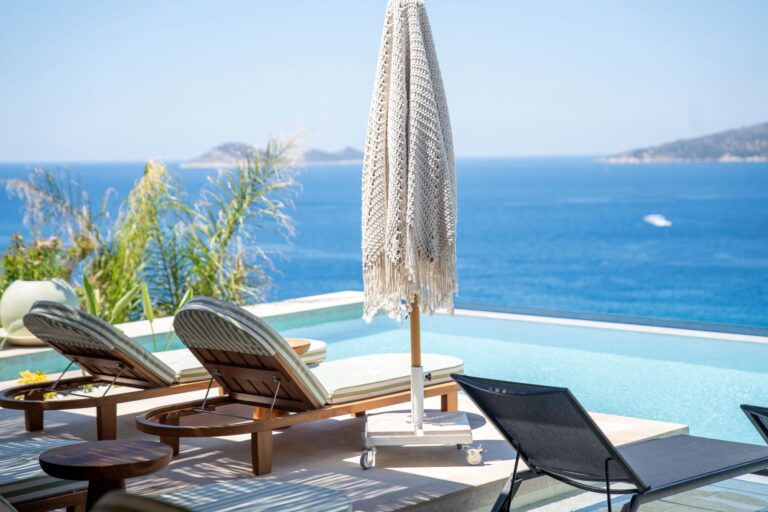 Infinity pool at Casa Pery in Kalkan with luxury sunbeds overlooking the Mediterranean Sea.