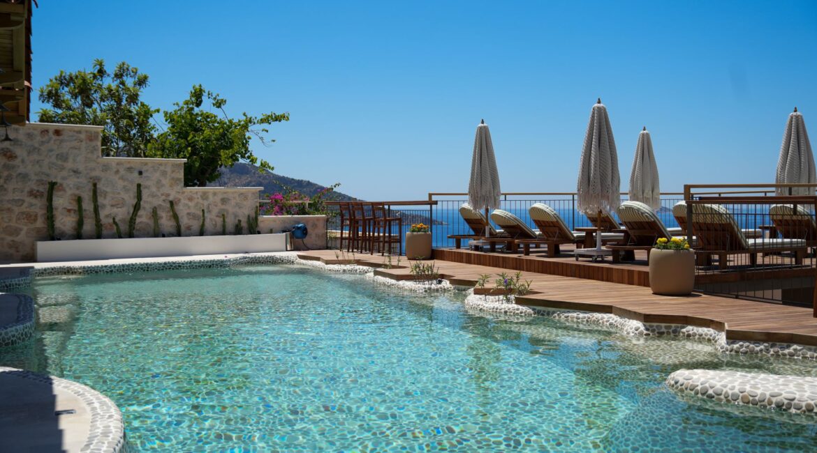 Infinity pool terrace at Casa Pery in Kalkan with sun loungers and sea views.
