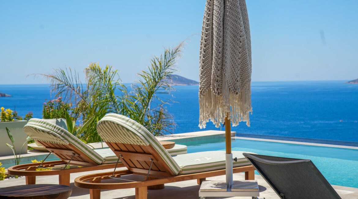 Infinity pool at Casa Pery in Kalkan with luxury sunbeds overlooking the Mediterranean Sea.