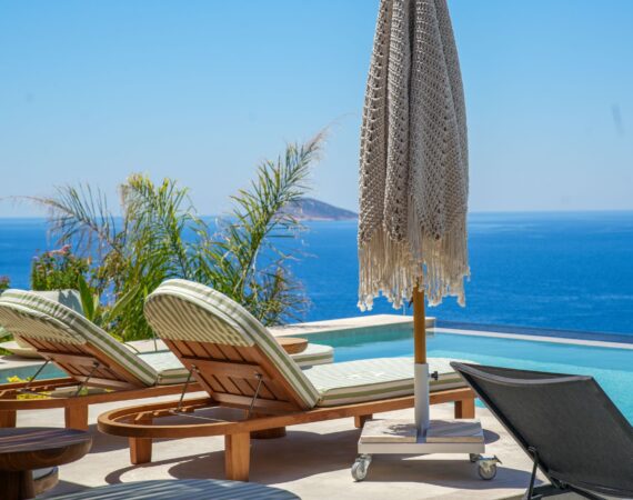 Infinity pool at Casa Pery in Kalkan with luxury sunbeds overlooking the Mediterranean Sea.