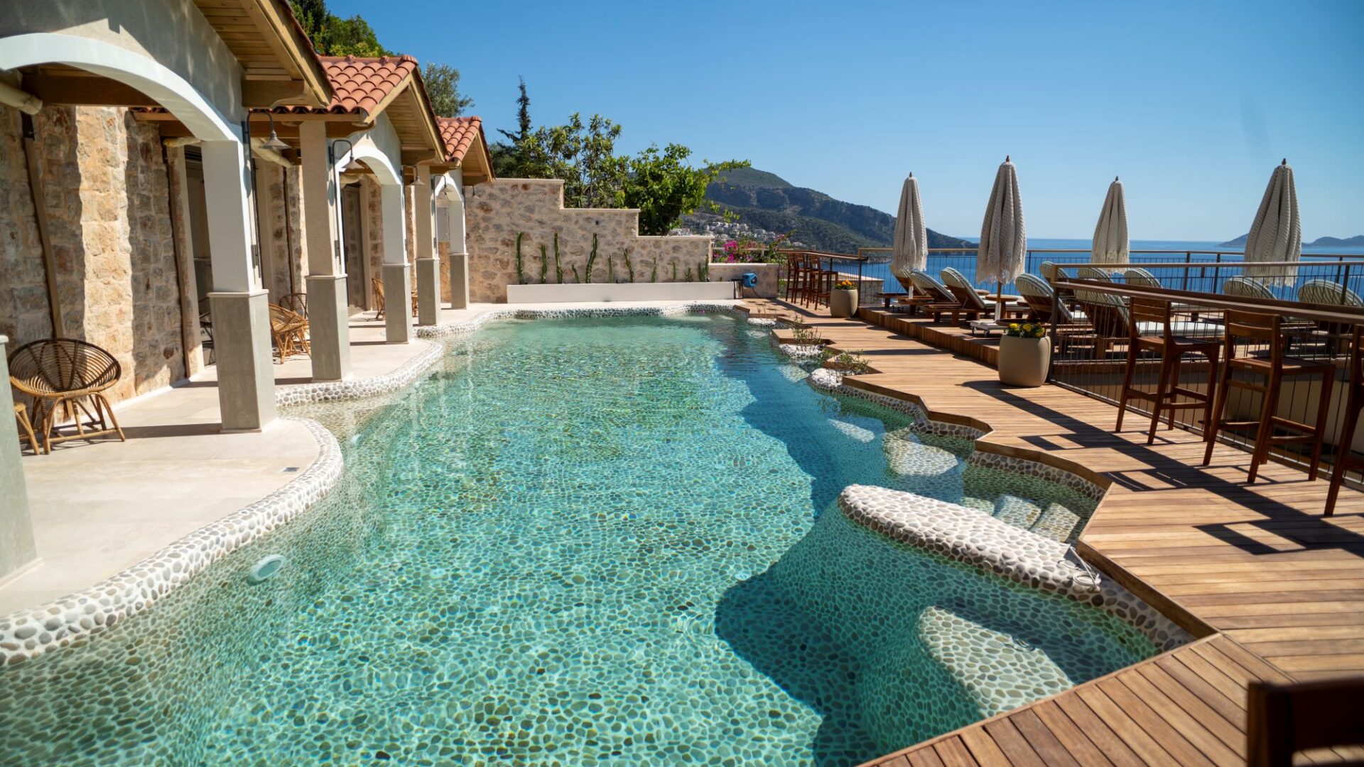 Swim-up room terraces overlooking the pebble pool at Casa Pery in Kalkan.