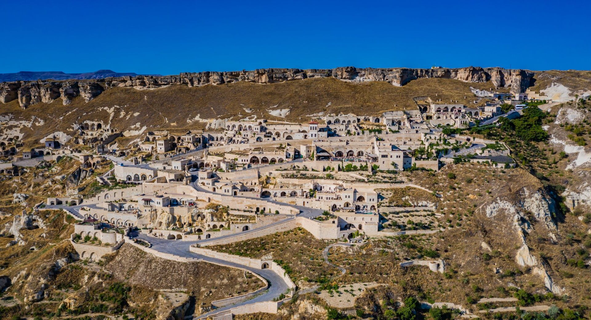 Aerial view of Kayakapı Premium Caves and the historic hillside of Ürgüp, Cappadocia