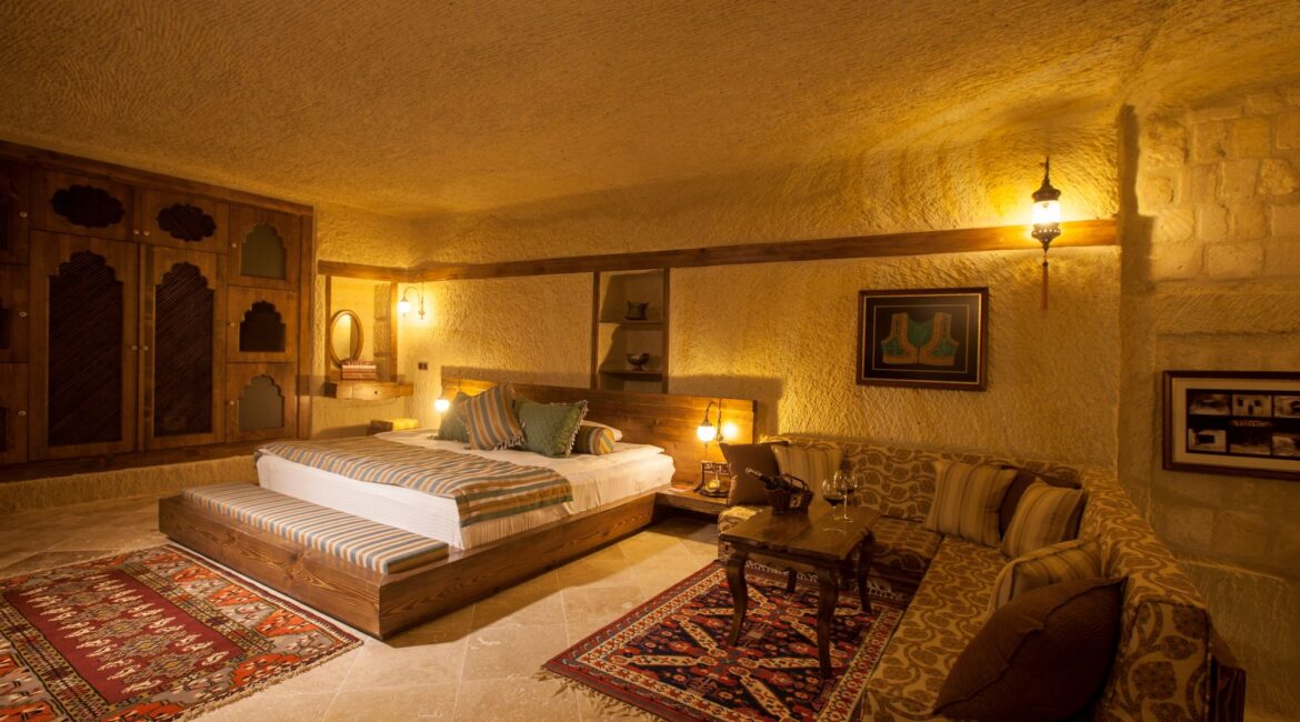Spacious family cave suite at Kayakapı Premium Caves in Cappadocia with separate living area and authentic stone interiors.