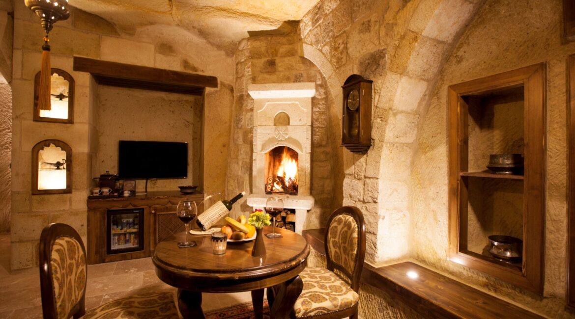 Luxury cave suite living room with restored stone features at Kayakapı Premium Caves, Cappadocia