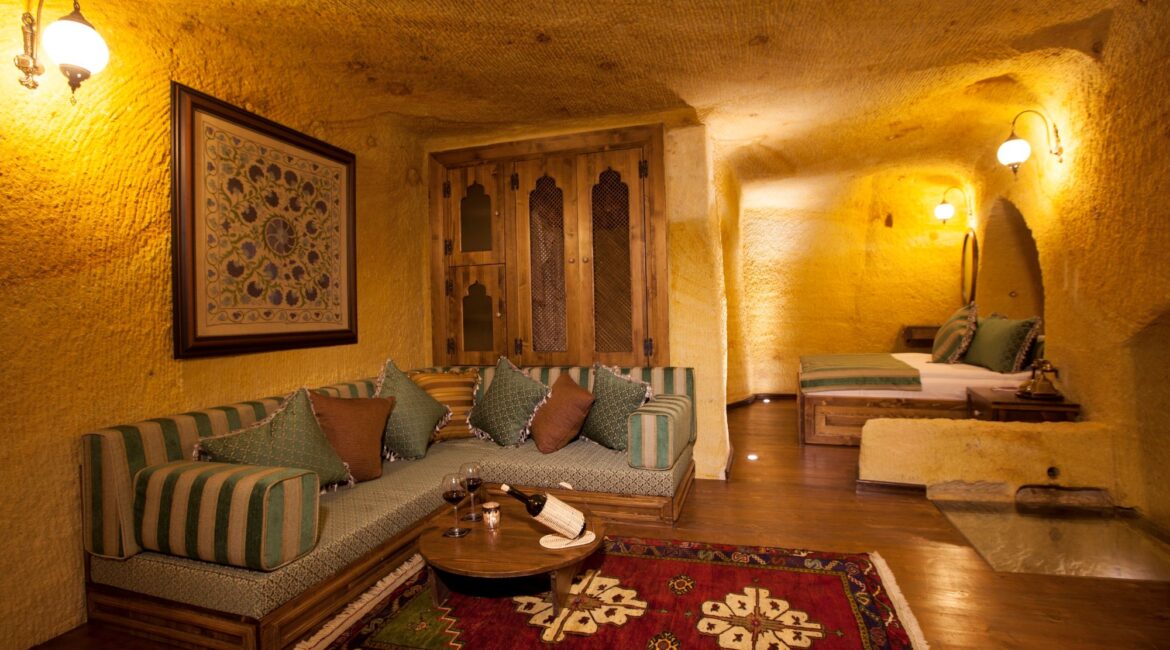 Spacious cave suite with elegant lounge area at Kayakapı Premium Caves, Cappadocia