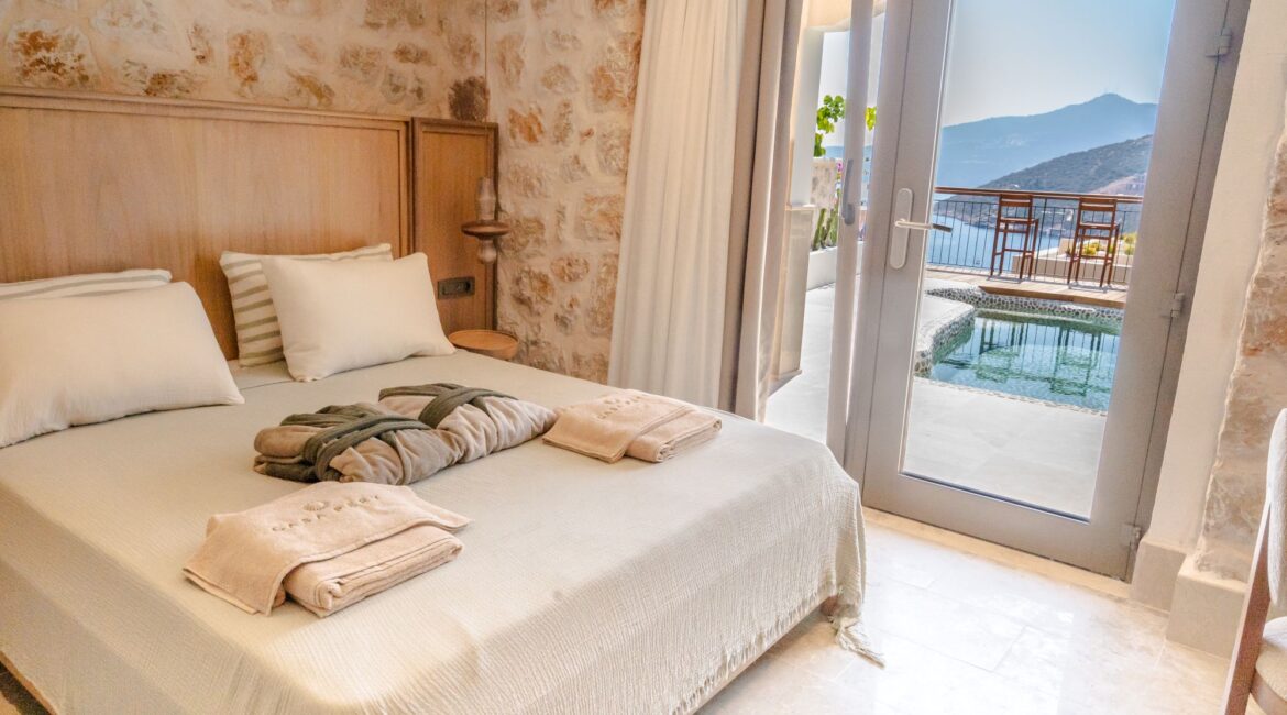 Swim Up Room 10 Solena at Casa Pery Hotel in Kalkan featuring elegant boutique interiors, natural stone walls and a private furnished terrace.
