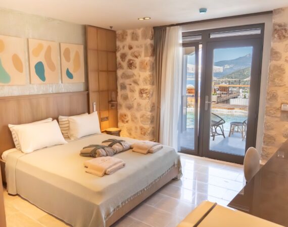 Boutique bedroom in Swim Up Room 12 Avelia at Casa Pery Hotel in Kalkan with stylish furnishings and a furnished terrace.