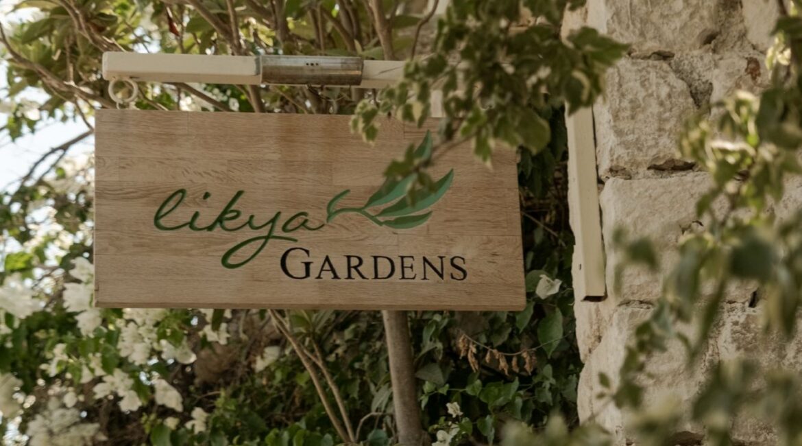 Likya Gardens hotel sign nestled among lush gardens at the boutique hotel in Kalkan, Turkey.