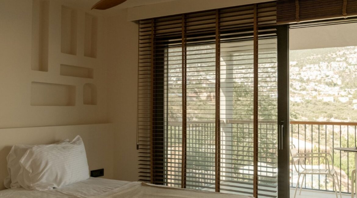 Comfort bedroom leading onto the balcony with panoramic Mediterranean views from a Comfort Suite at Likya Garden
