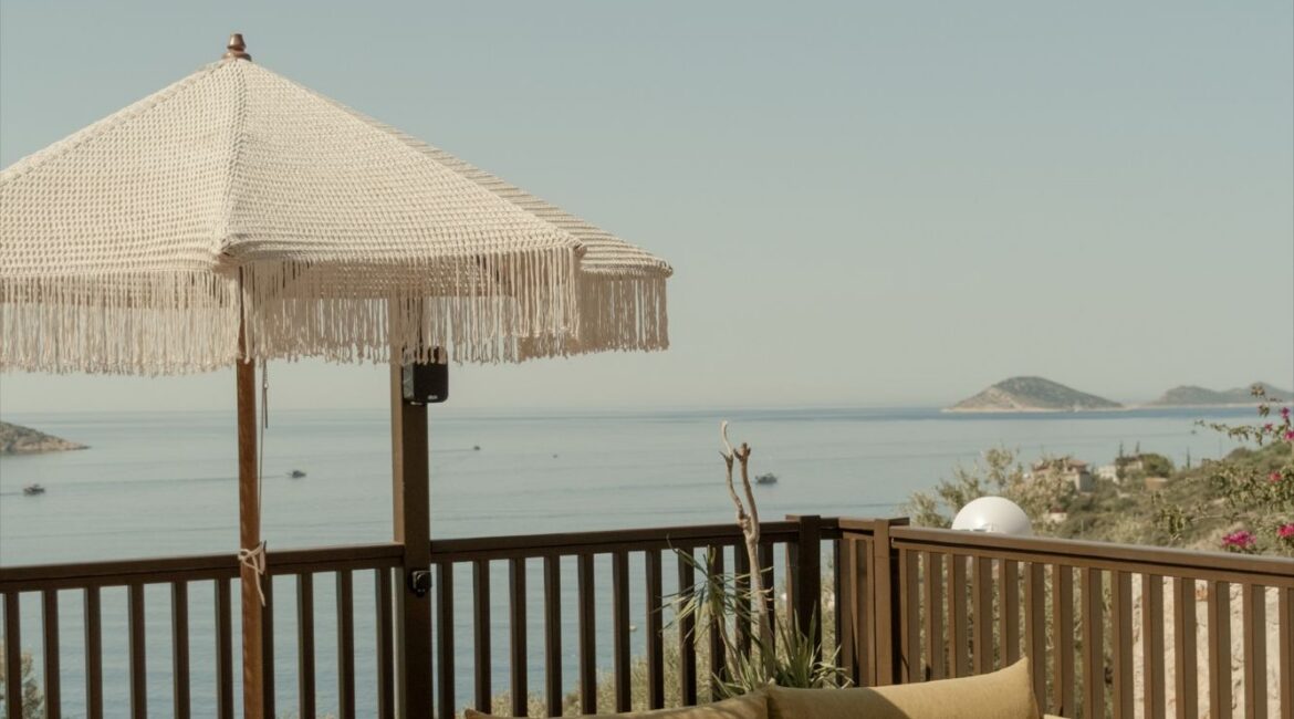 Poolside relaxation area with comfortable seating overlooking Kalkan Bay at Asfiya Sea View.