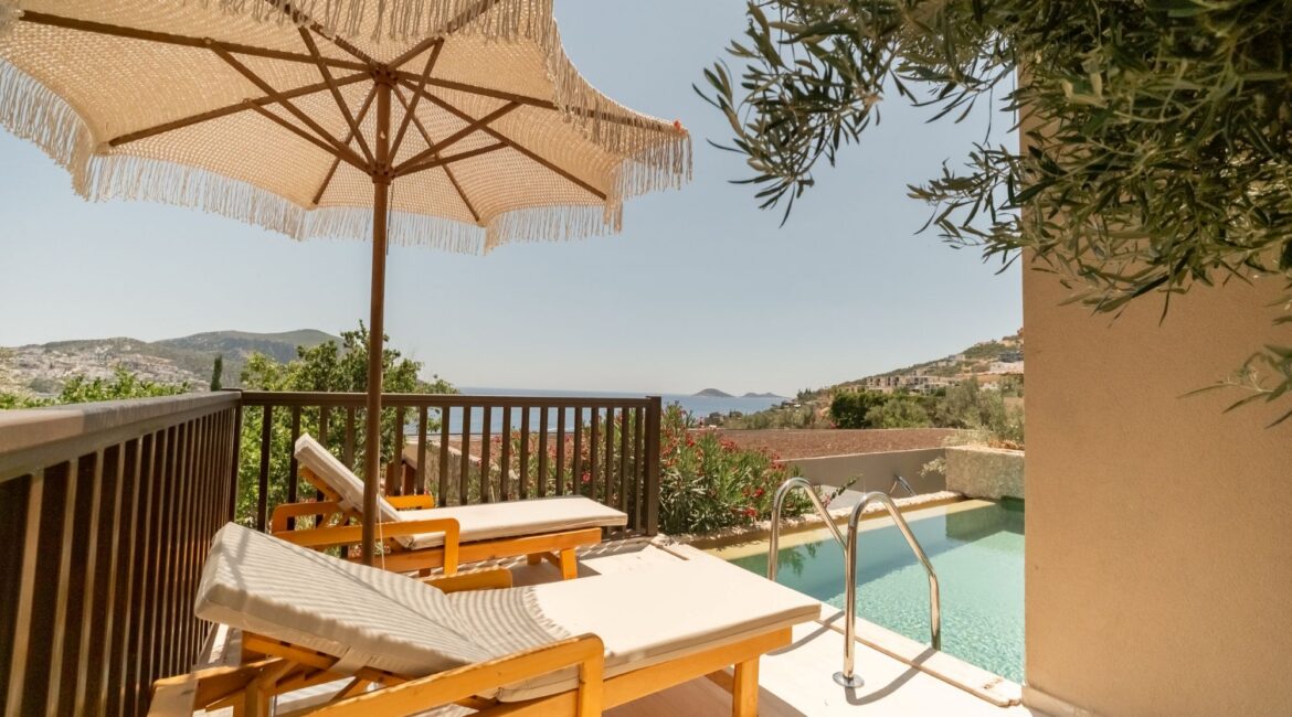 Private pool terrace with sun loungers outside a Premium Pool Room at Asfiya Sea View overlooking Kalkan Bay.